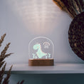Load image into Gallery viewer, Nachtlicht aus Acryl "bunter Dino", Holzfuß graviert, Geschenk zur Geburt , Personalisierte Erinnerungsstücke, Geschenke für Kinder, LED